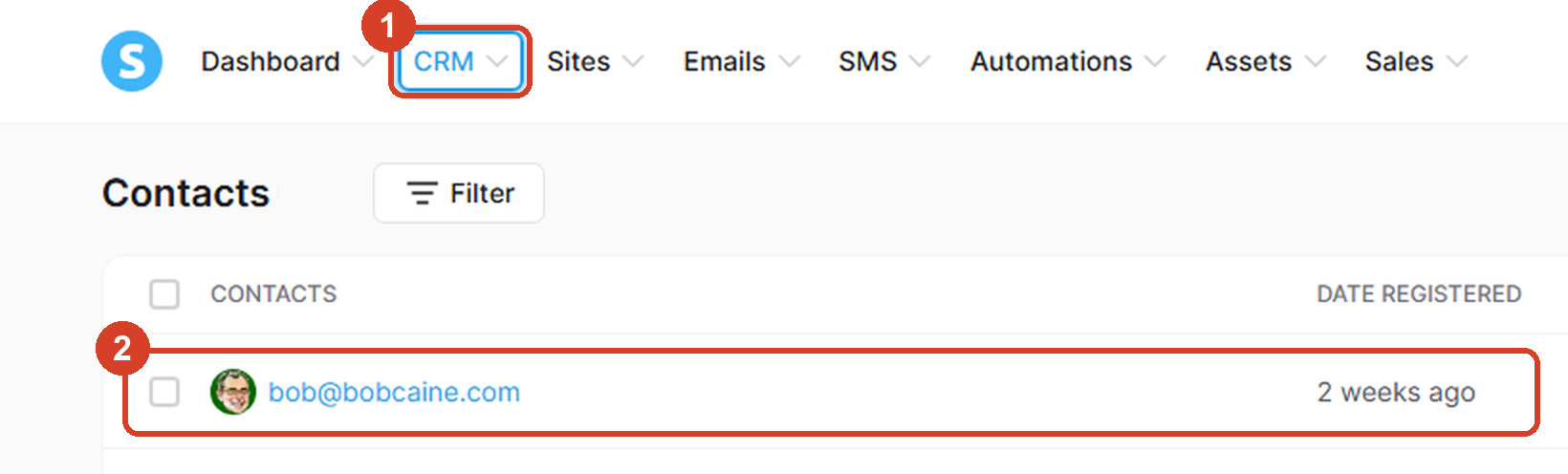 Systeme.io's Contacts screen. 1: the CRM menu at the top. 2: the test email address in the contact list.